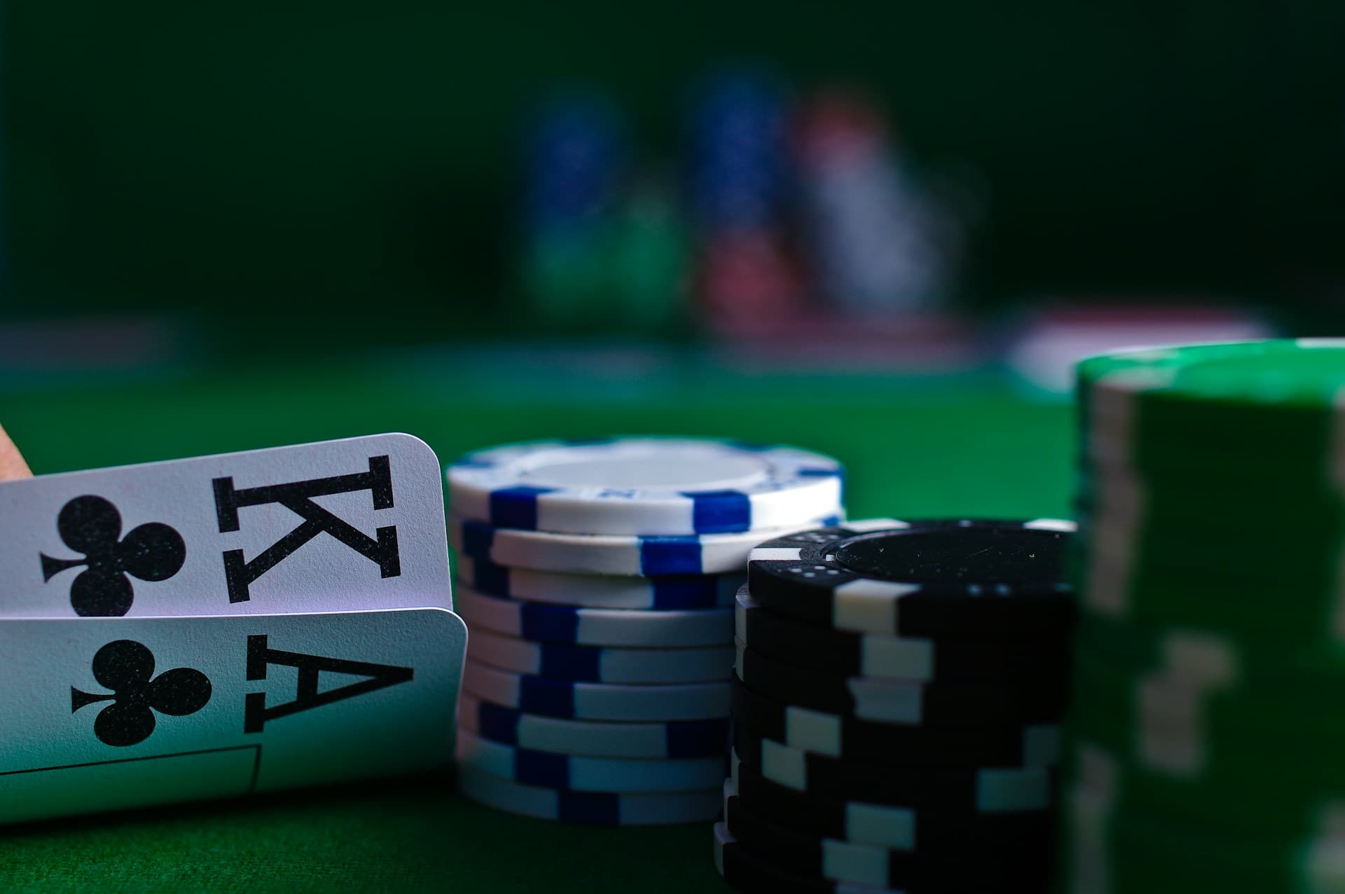 Playing cards fanned on a dark surface in soft focus evening light